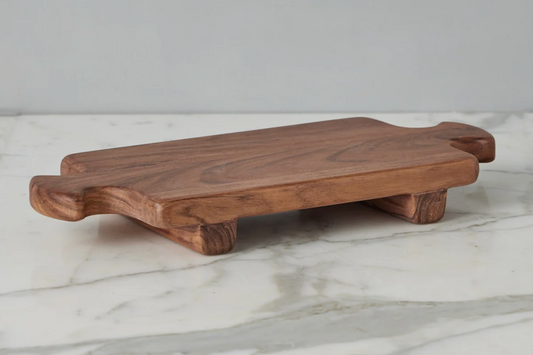 Wooden cutting board on a marble surface with a gray background
