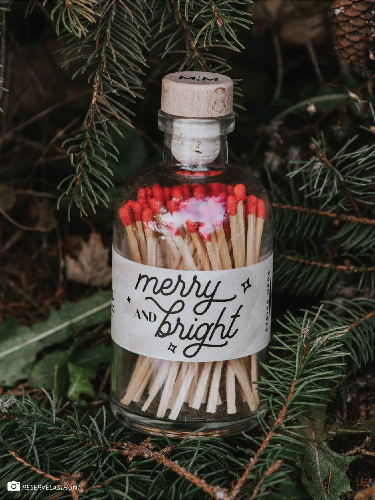 Merry & Bright apothecary matches styled beside a seasonal candle and holiday greenery.