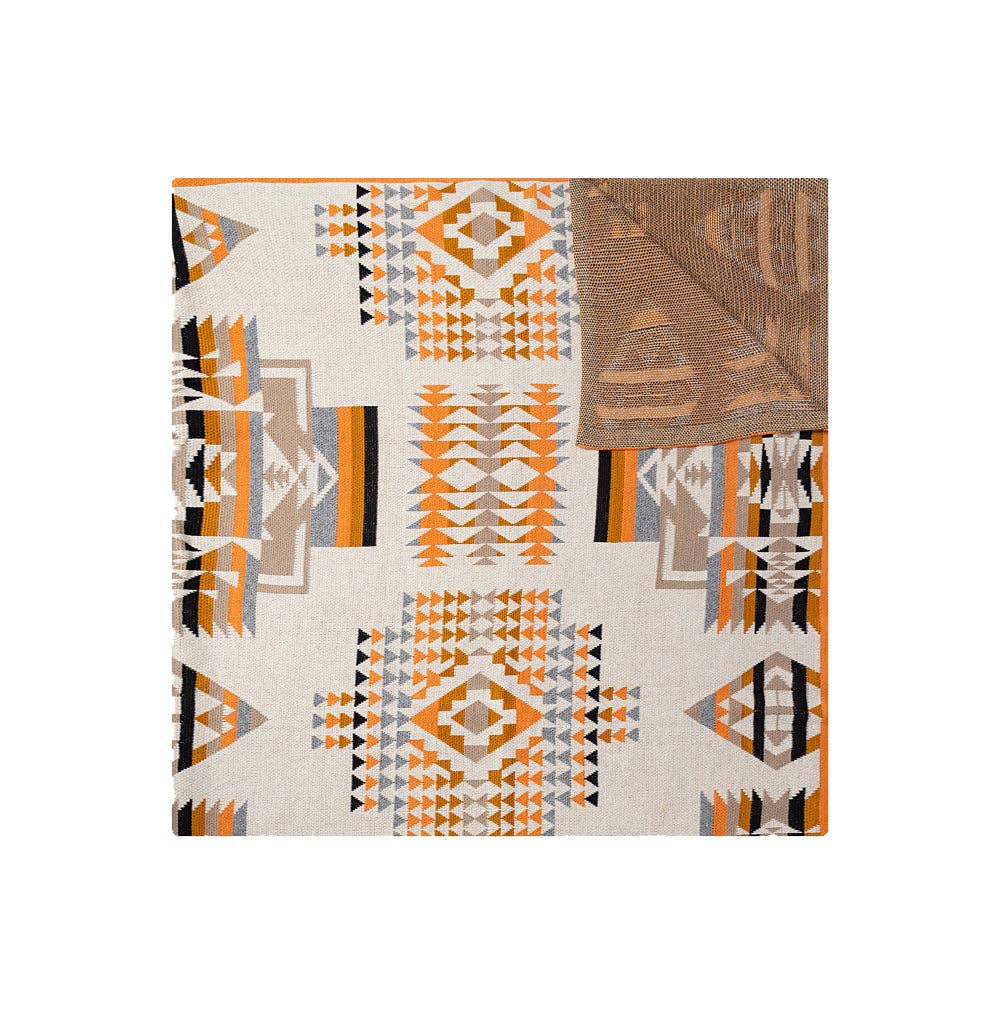 Talon Ridge Mesa Woven Throw Blanket featuring a tribal-inspired Southwestern pattern in soft ivory and peach tones.