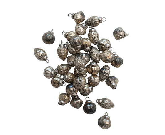 Set of 36 mini embossed mercury glass ornaments with an antique silver finish and muslin storage bag.