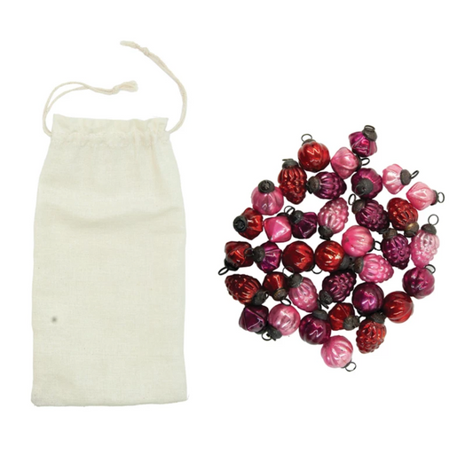 Set of 36 mini embossed mercury glass ornaments in red, pink, and fuchsia with a muslin storage bag.