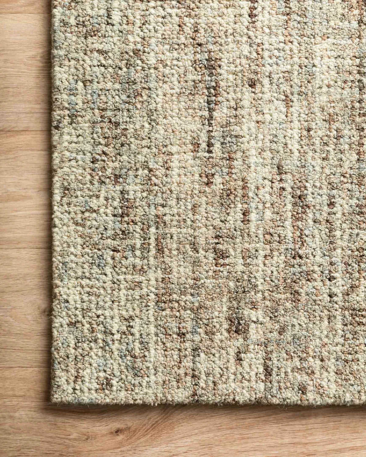 Close-up of the Harlow wool rug highlighting the hand-tufted texture, natural wool fibers, and subtle mocha and mist color variation.