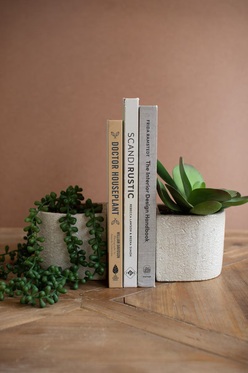 White concrete bookend planters adding sculptural style and greenery to a modern, collected home.