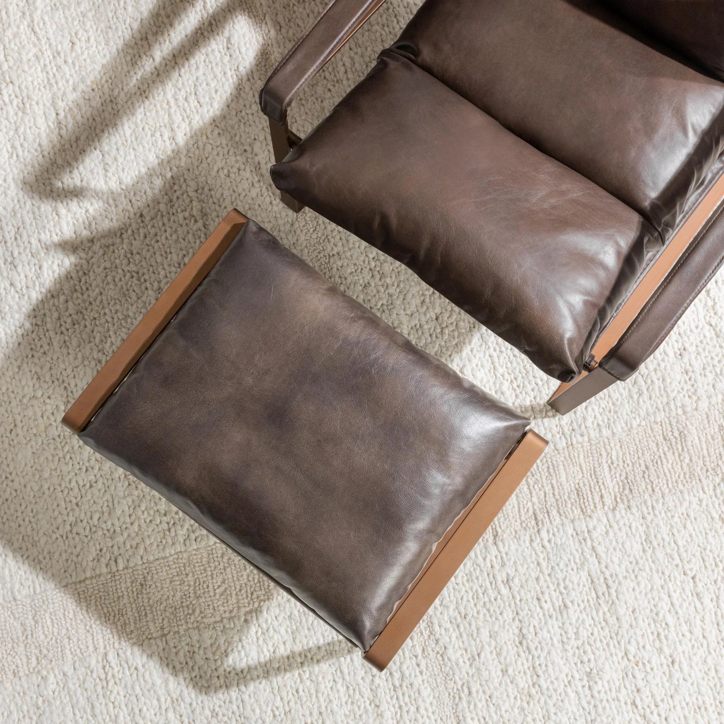 Morgan Leather Ottoman in Truffle Brown featuring premium top grain leather upholstery and a sleek black iron frame.