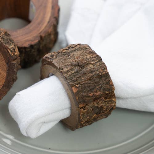 Round light natural wood napkin ring with an organic bark edge.