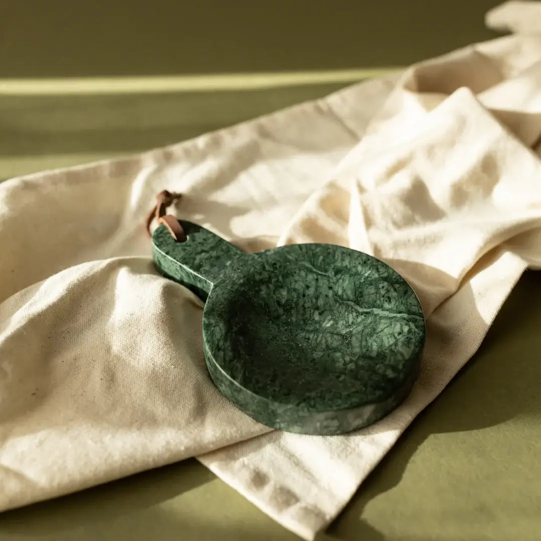 Genuine marble spoon rest styled on a kitchen countertop with wood utensils, ceramic bowls, and natural textures for a timeless, collected look.