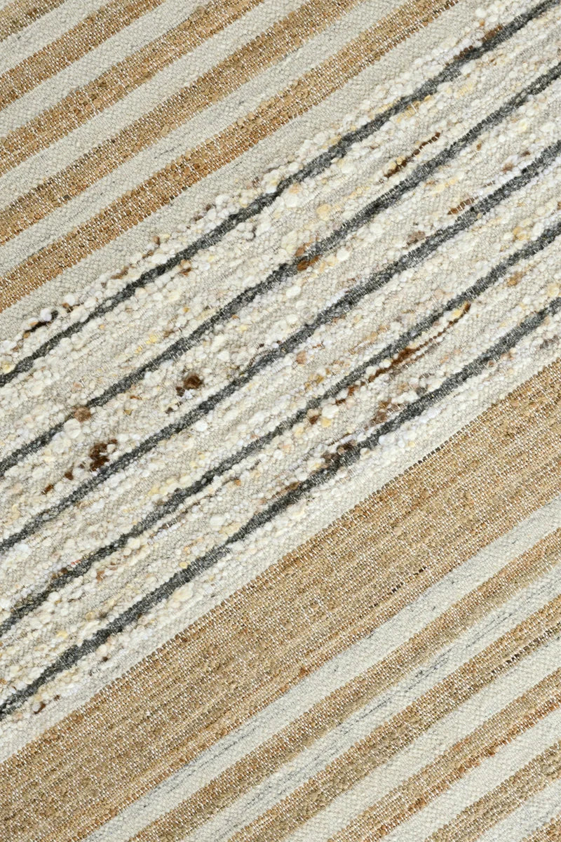 Close-up of the Pego Stripe rug highlighting the rich woven texture and natural blend of jute, wool, and cotton fibers.