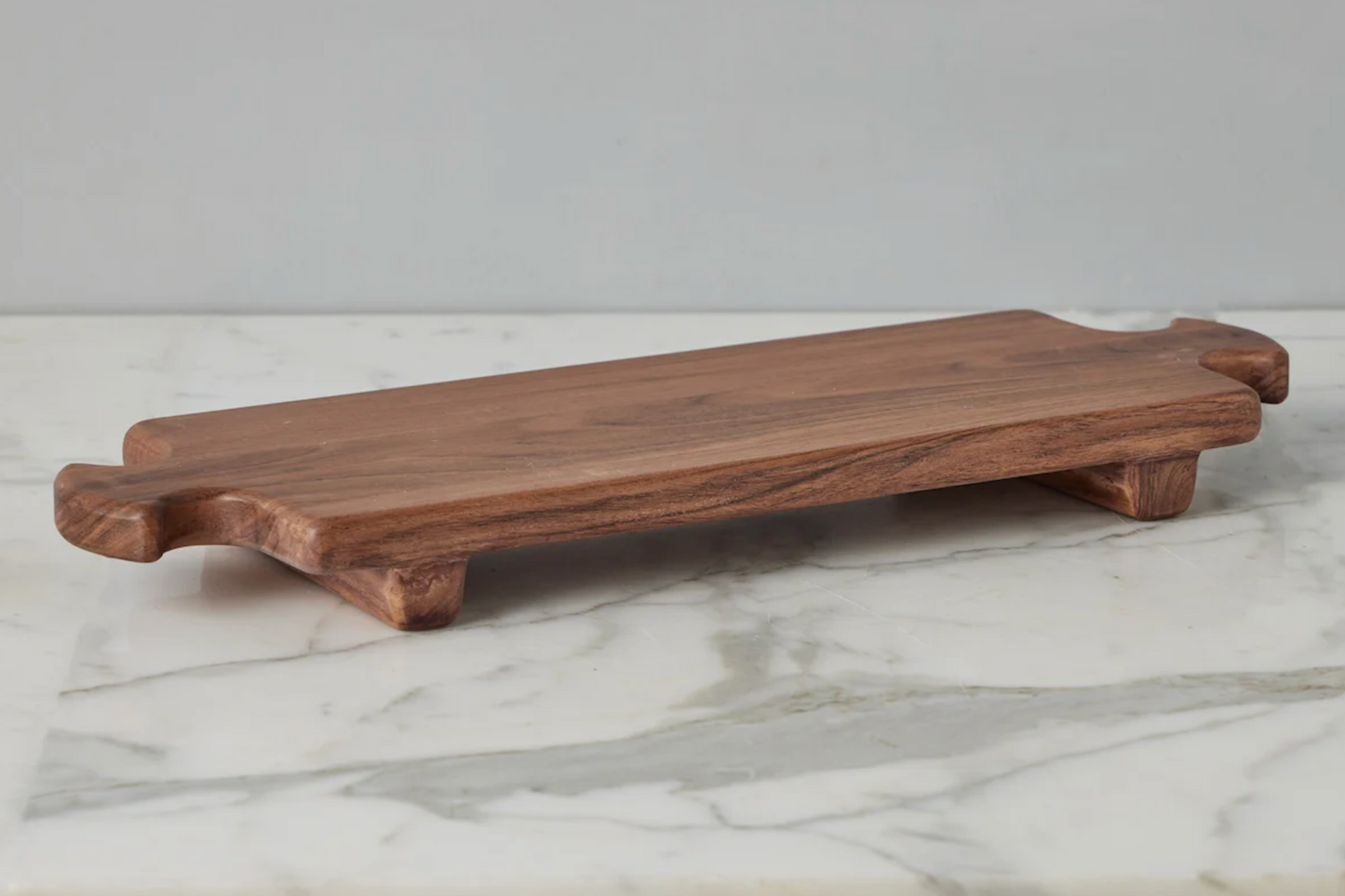 Wooden cutting board on a marble surface