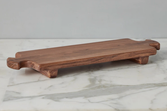 Wooden cutting board on a marble surface