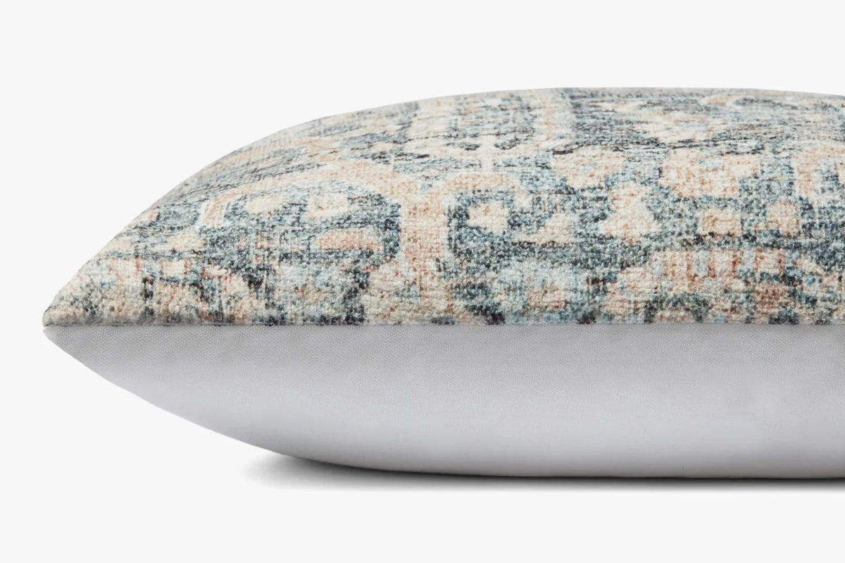 Close-up of the Humboldt pillow highlighting the woven texture, ocean blue and clay tones, knife-edge finish, and hidden zipper with antique bronze Loloi logo pull.