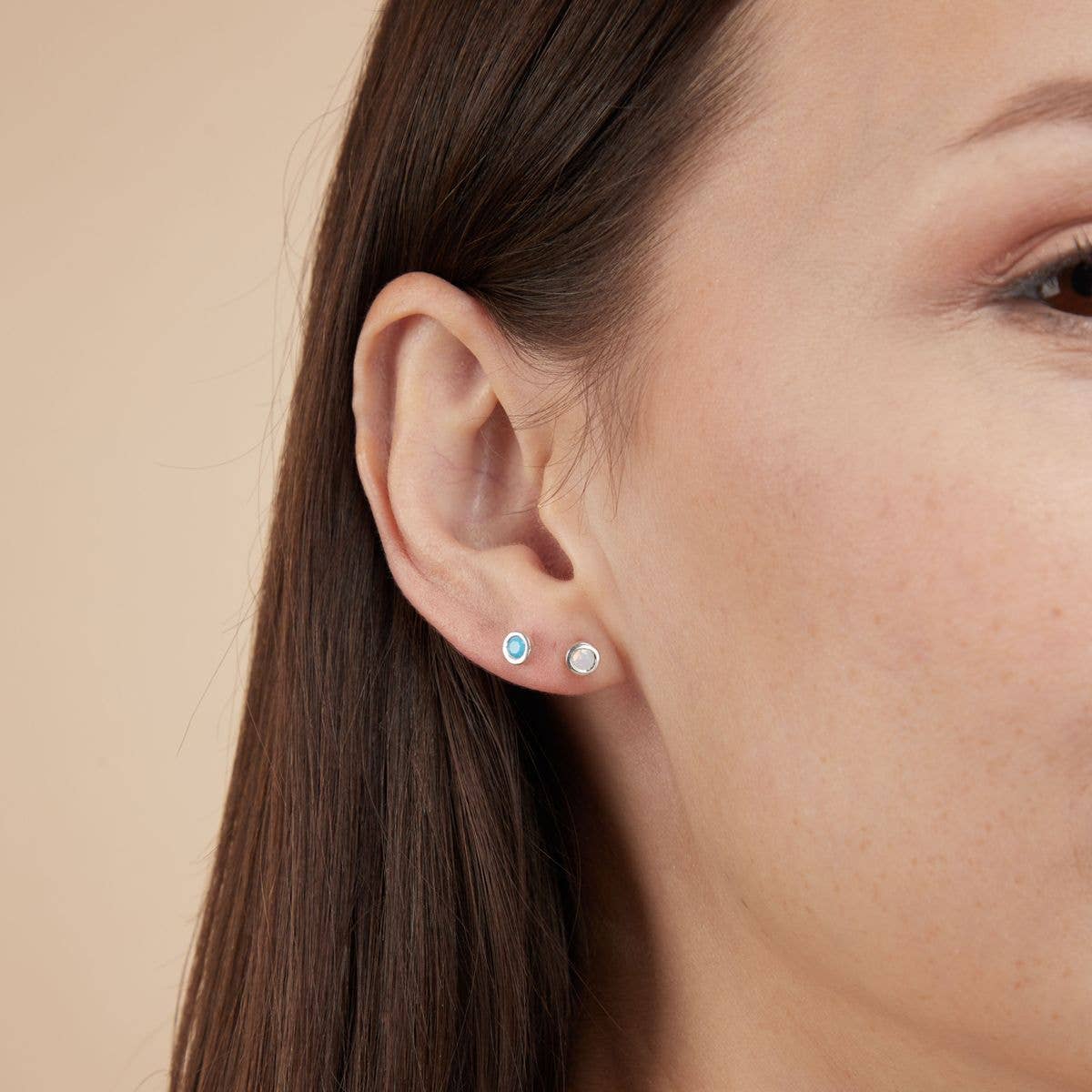 Iridescent lab-created opal nano gemstones set in hypoallergenic sterling silver stud earrings.