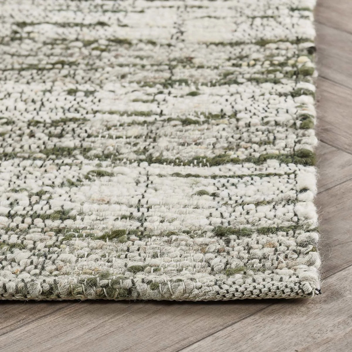 Close-up of the Perth rug showcasing the lofty hand-carded wool, woven striped pattern, and artisan craftsmanship.