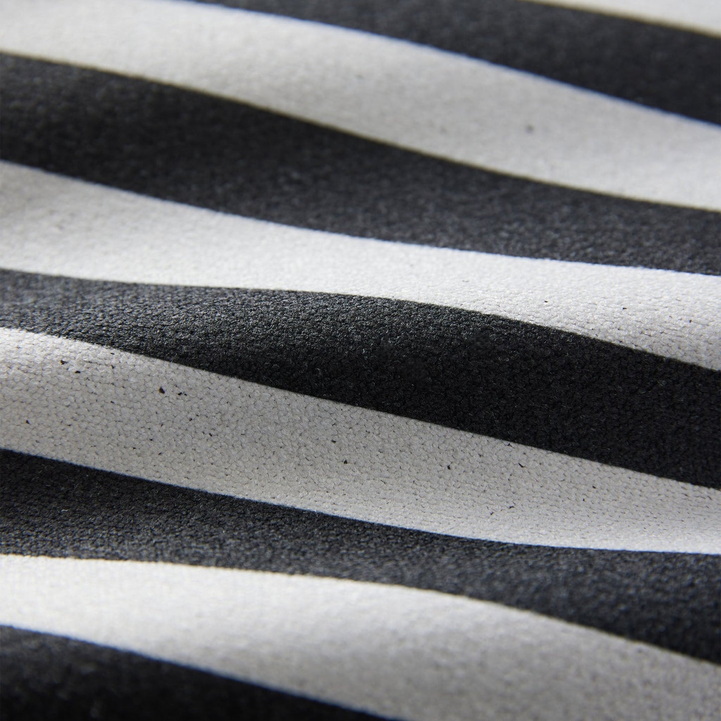 Close-up of the Poolside Black Nomadix towel highlighting the textured performance fabric, striped pattern, and built-in hanging loop.