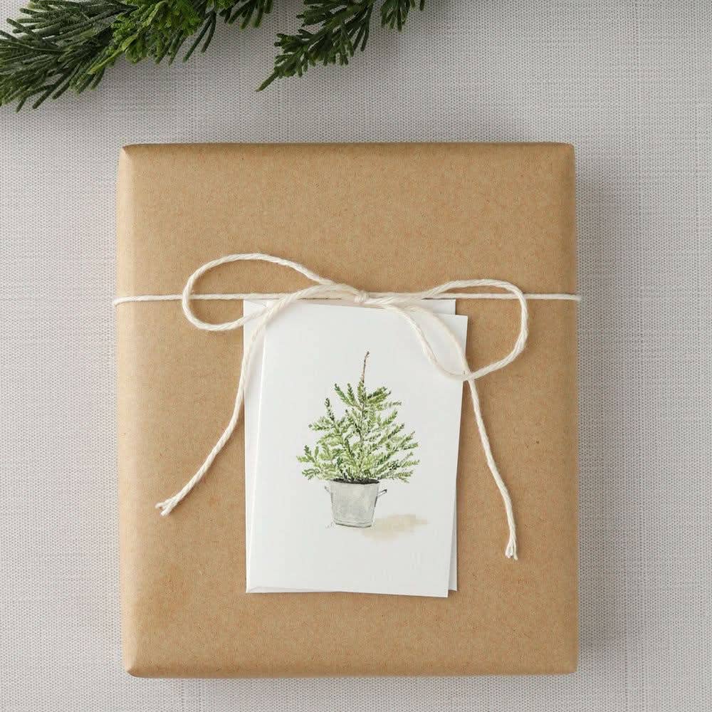 Close-up of the Potted Tree Mini Notecard printed on premium 120 lb superfine paper with a blank interior for handwritten holiday messages.