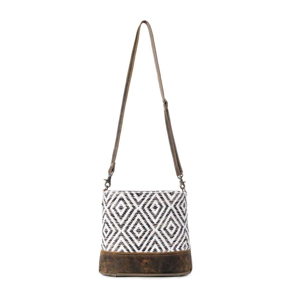 Handbag with geometric pattern and brown base on a white background