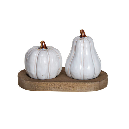 Stoneware pumpkin and gourd salt and pepper shakers in white and natural reactive glaze displayed on a wood tray.