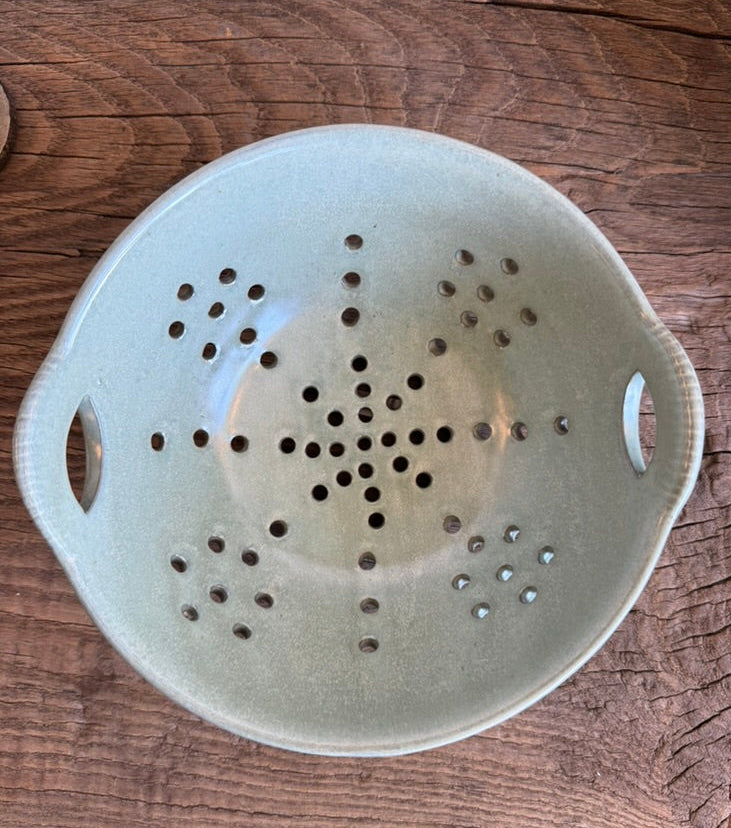 Close-up of the naturally varied aqua reactive glaze on the stoneware berry bowl.