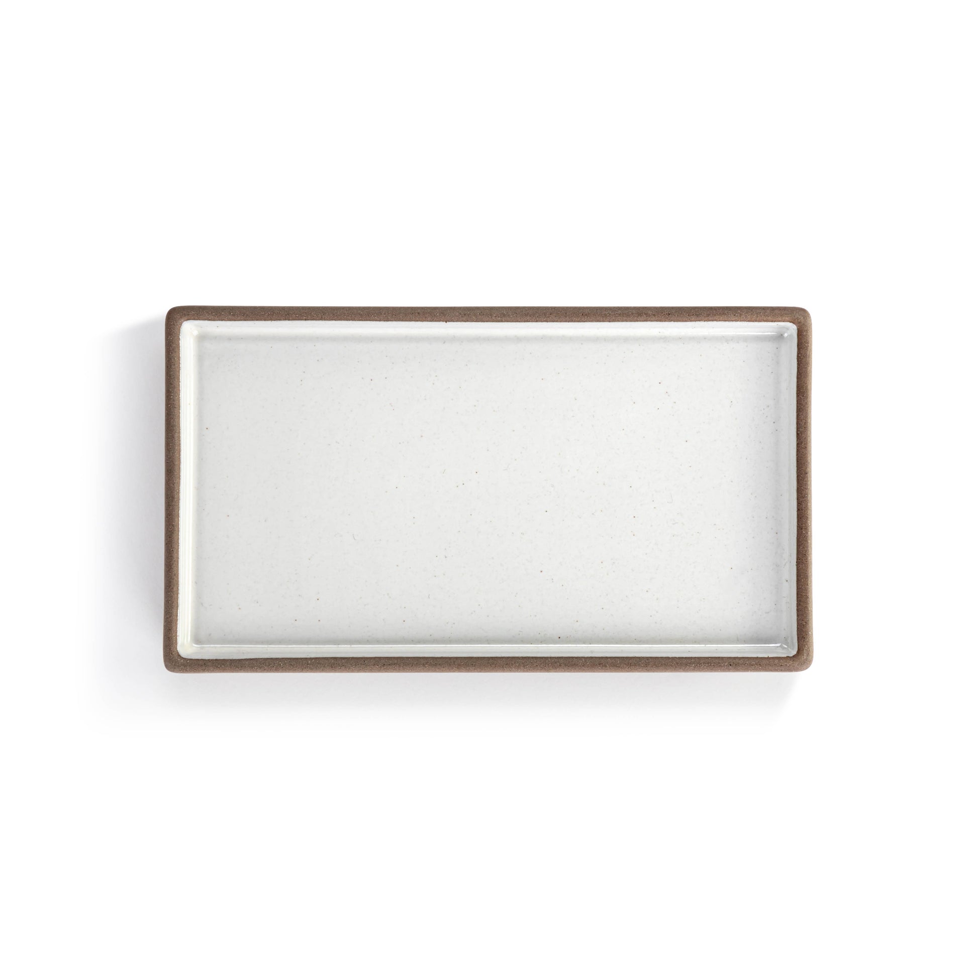 Small ceramic tray with a white and natural finish for decorative organization.
