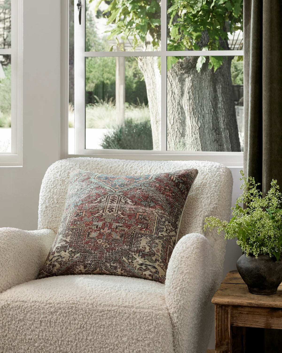 Redwood Rust and Multi throw pillow styled on a linen sofa with leather accents, reclaimed wood furniture, and layered neutral textiles in an organic modern living room.