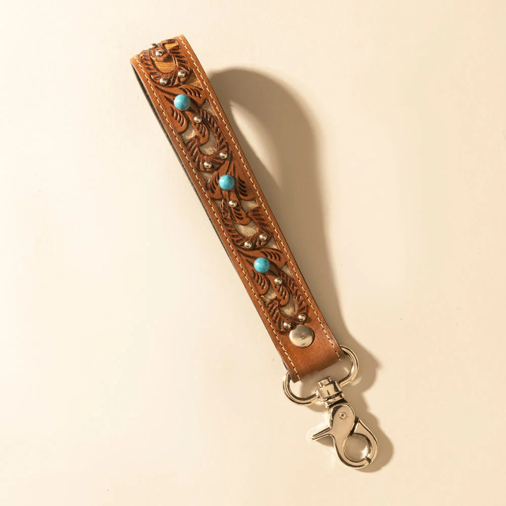 River Glen hand-tooled leather and hair-on hide key fob in honey tan with turquoise accents and metal clasp.