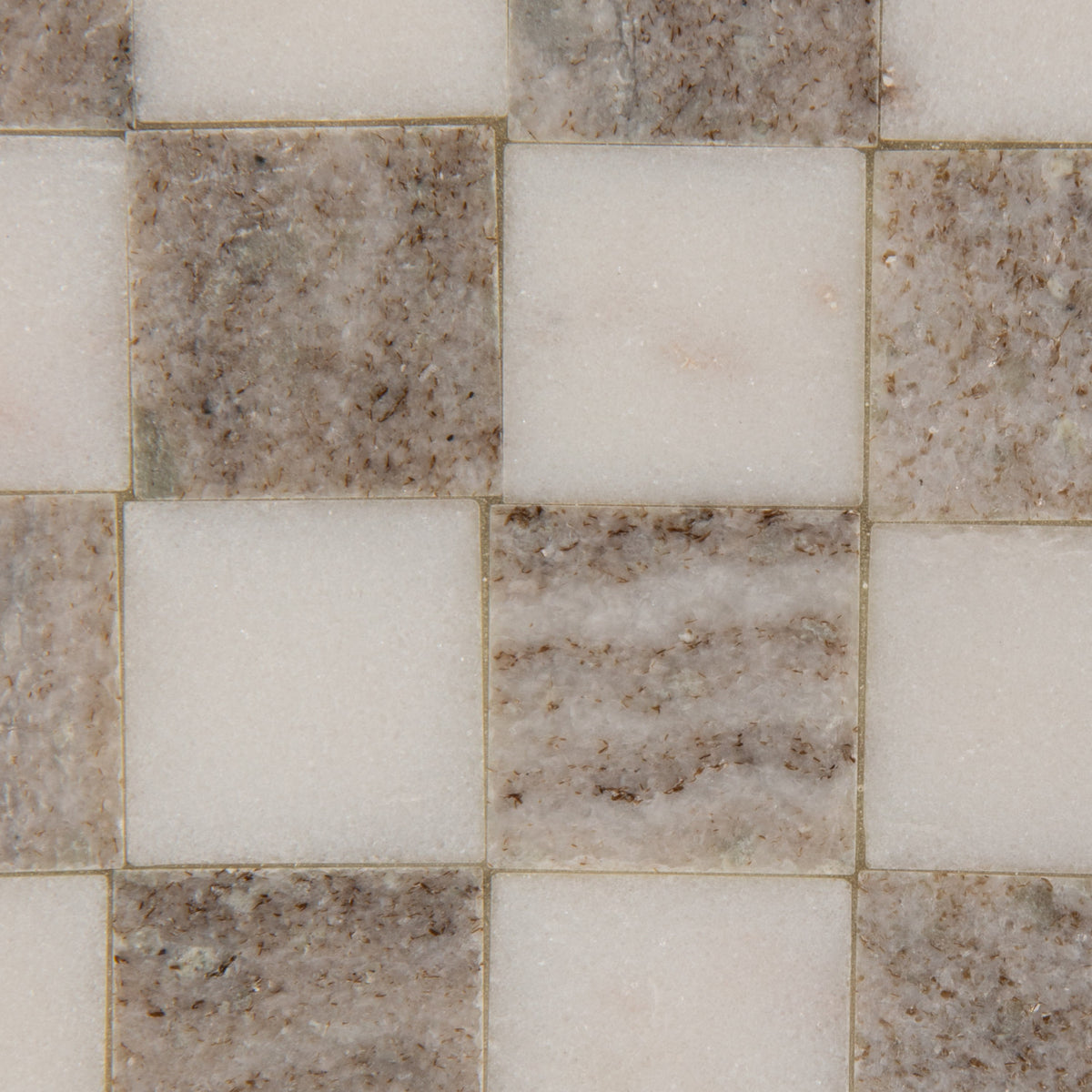 Close-up of buff and white checkered marble tray showing natural stone veining and geometric pattern.