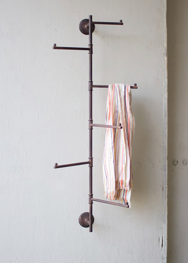 Rustic wall-mounted coat rack with rotating swivel hooks.
