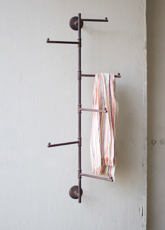 Rustic wall-mounted coat rack with rotating swivel hooks.
