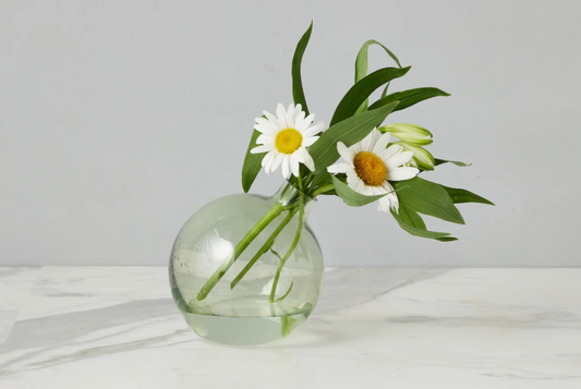 Sage green glass sphere bud vase with organic handcrafted shape styled with fresh greenery