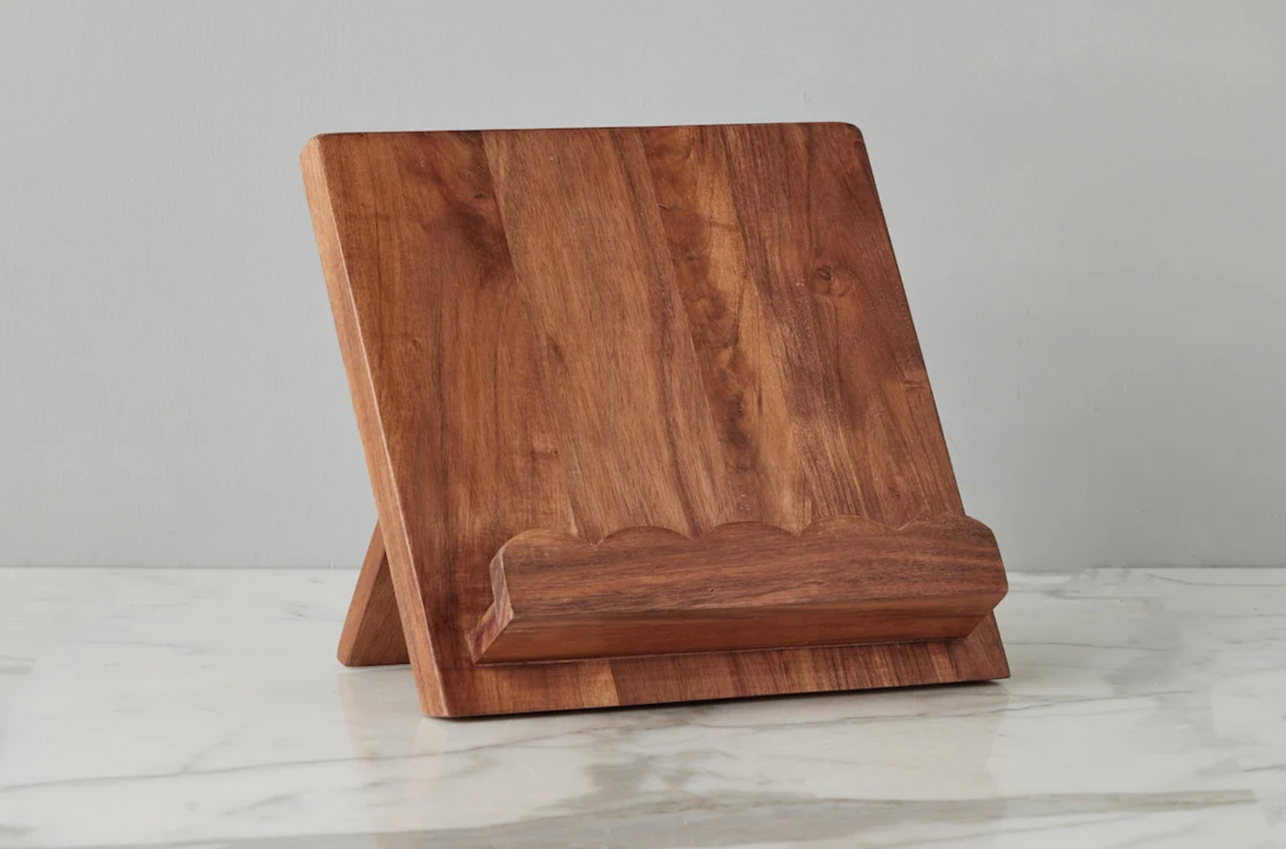 Wooden tablet stand on a light gray surface