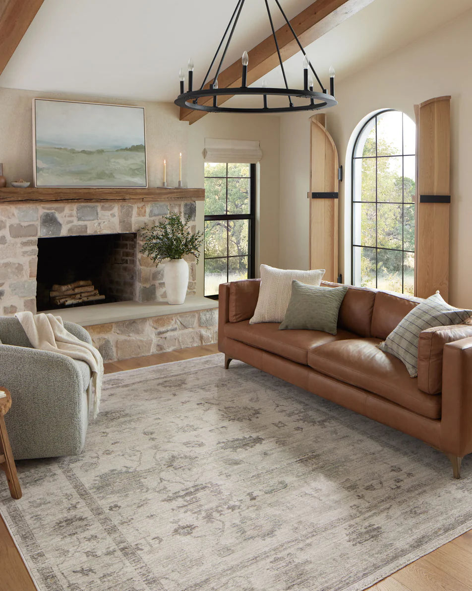 Scarlett down throw pillow layered on a neutral sofa in an organic modern living room.