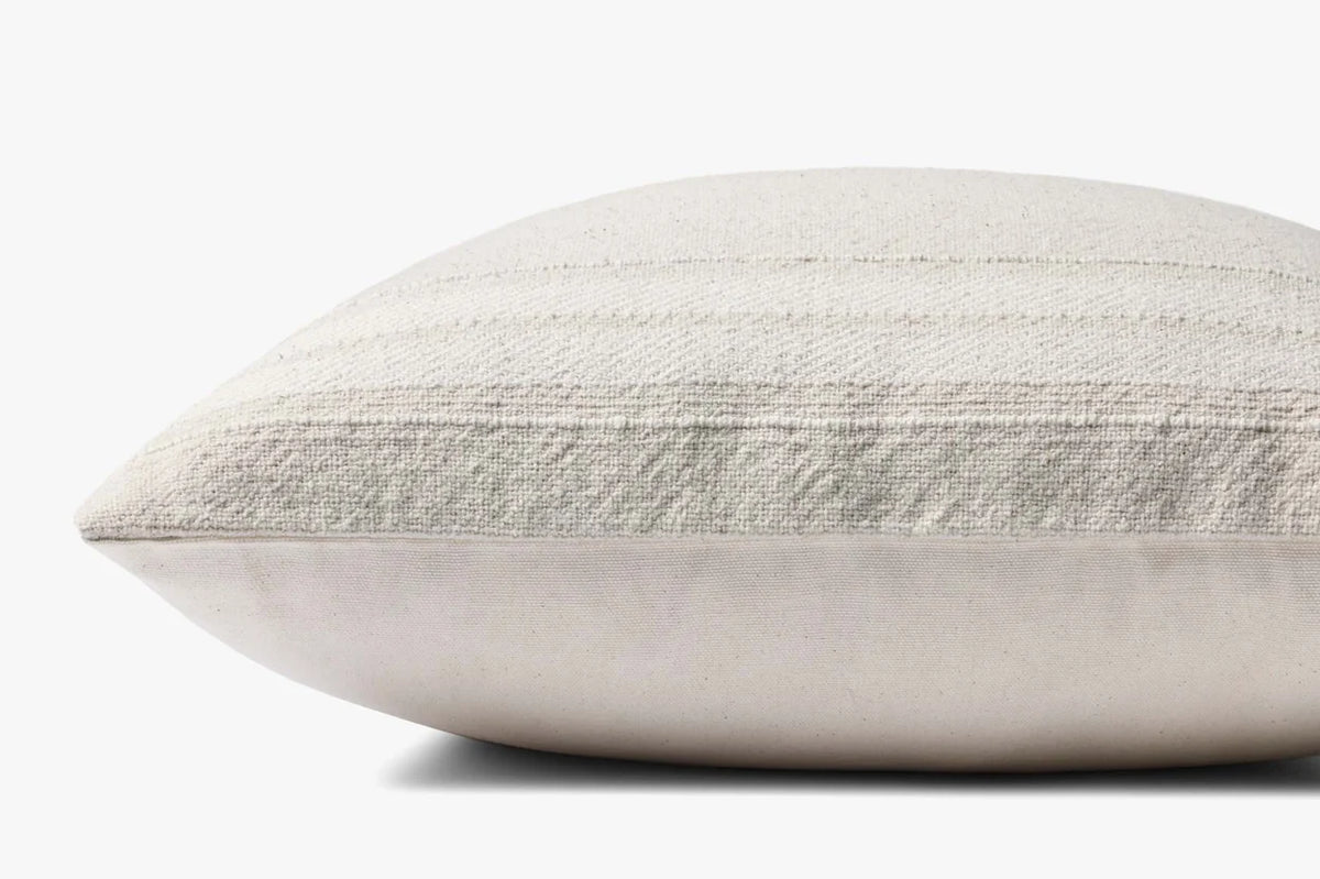 Close-up of the Selena pillow showcasing the woven cotton texture, knife-edge finish, and hidden zipper with antique bronze Magnolia Home logo pull.