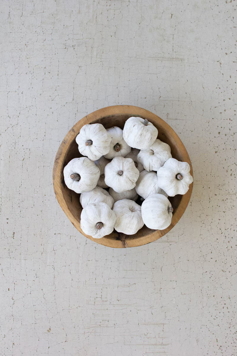 White mini faux pumpkins arranged in a wooden bowl as a neutral autumn centerpiece.