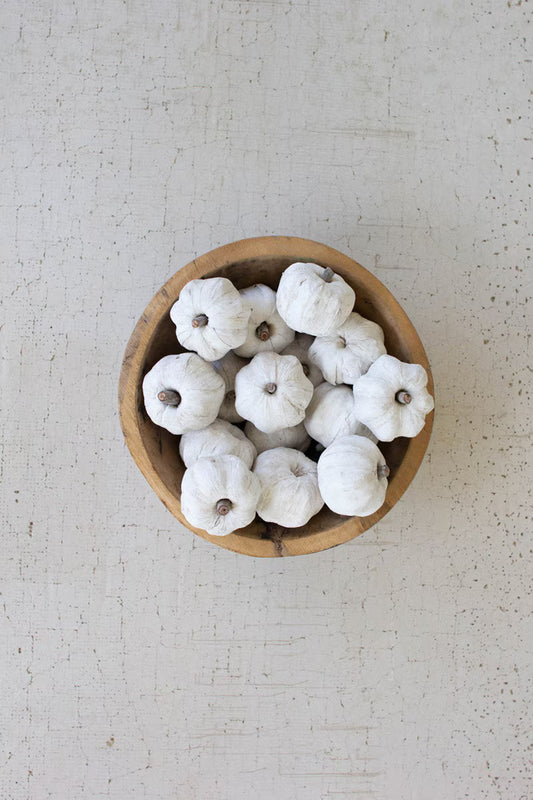 White mini faux pumpkins arranged in a wooden bowl as a neutral autumn centerpiece.