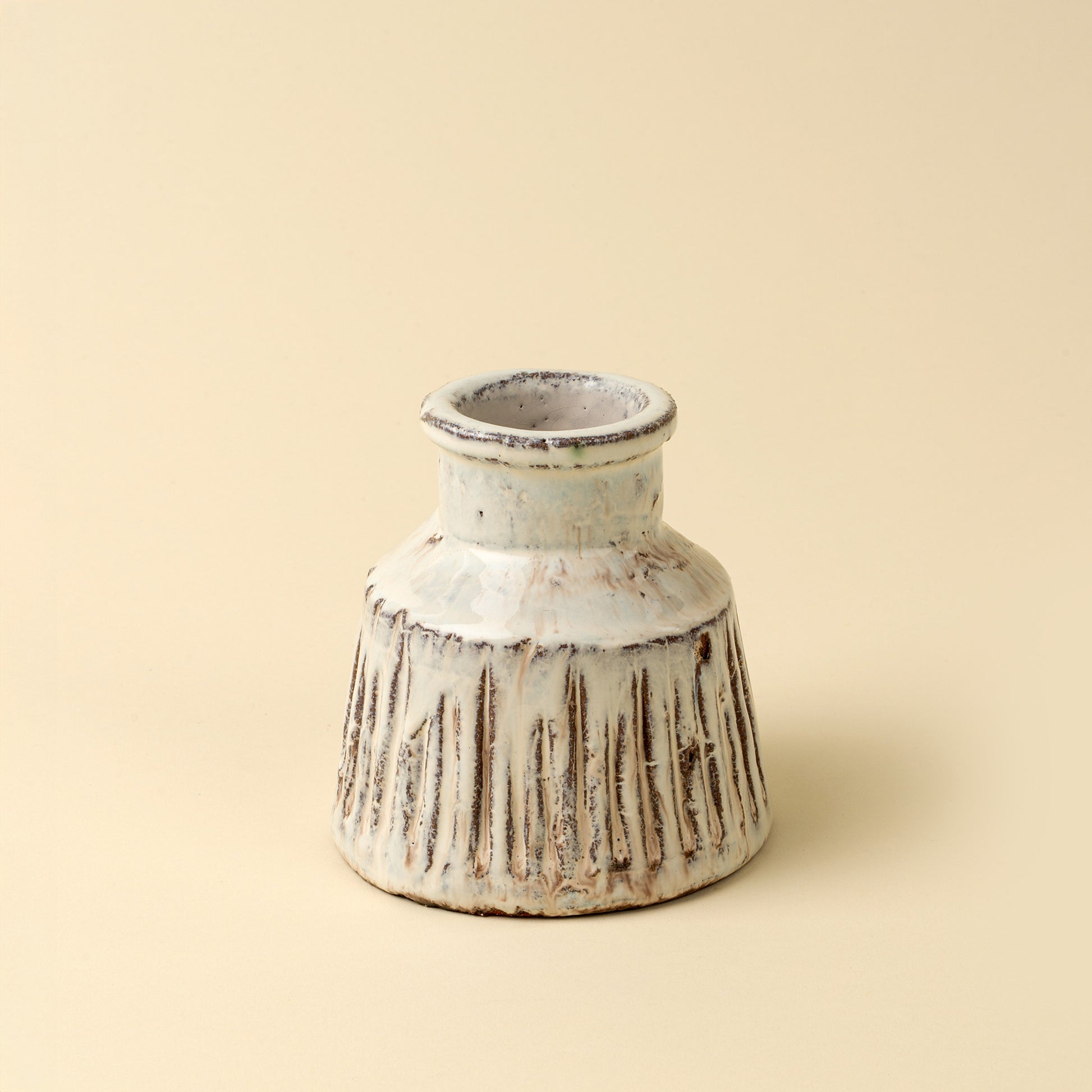 The Solara Ridge Vase handcrafted from terracotta with a glossy cream glaze finish.