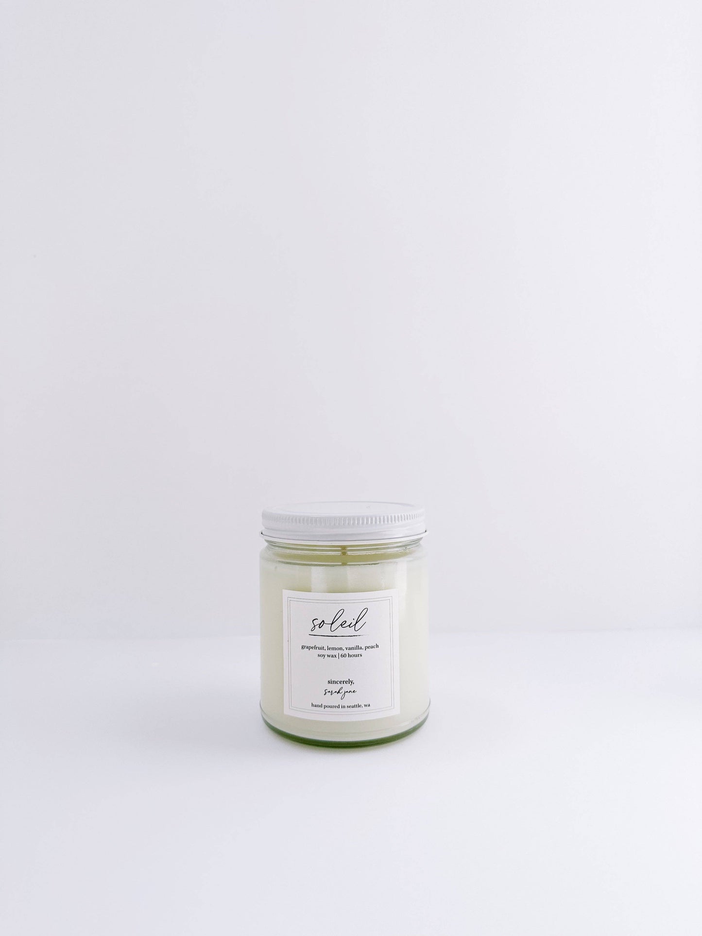 Soleil soy candle featuring a bright citrus fragrance with soft peach and creamy vanilla notes.