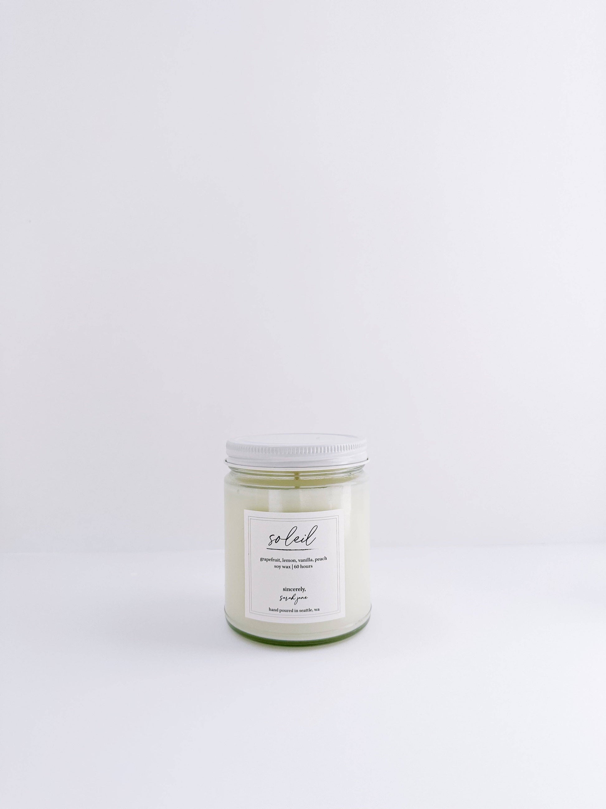 Soleil soy candle featuring a bright citrus fragrance with soft peach and creamy vanilla notes.