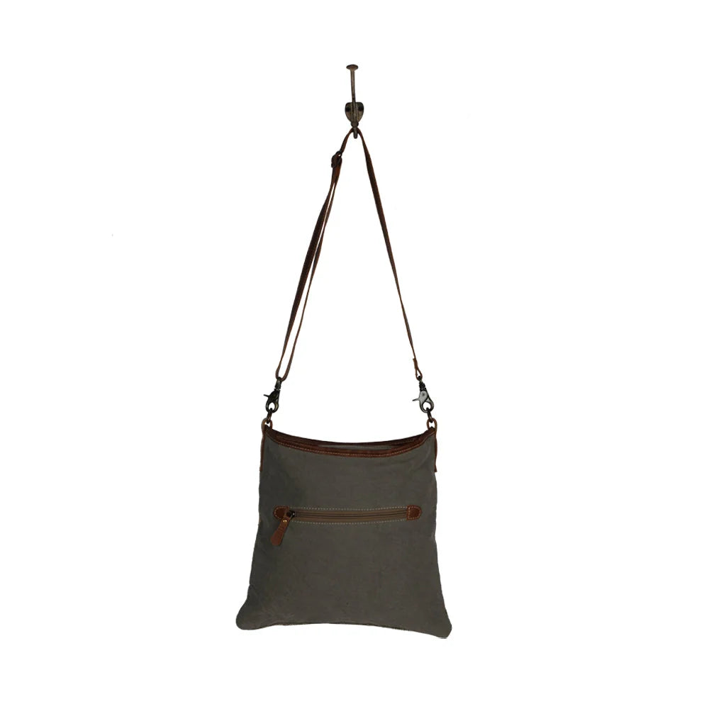 Angle Tangle shoulder bag crafted from patterned woven rug textile, canvas, and genuine leather.