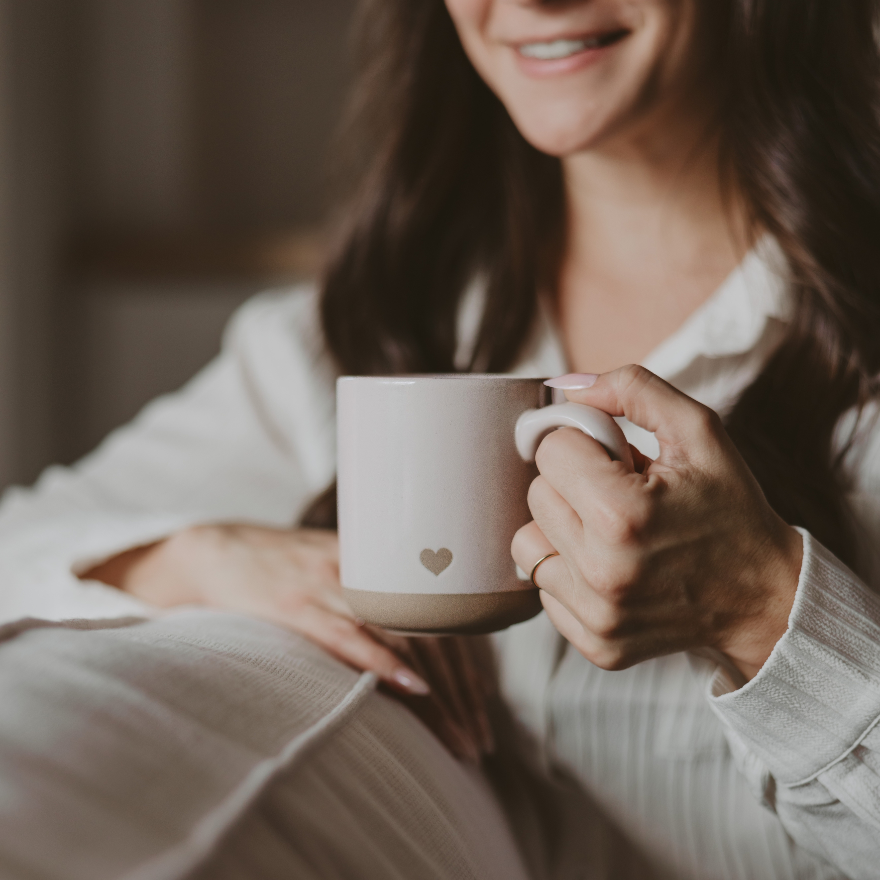 Artisan-inspired cream stoneware mug with a heart design, perfect for gifting or enjoying everyday coffee and tea.