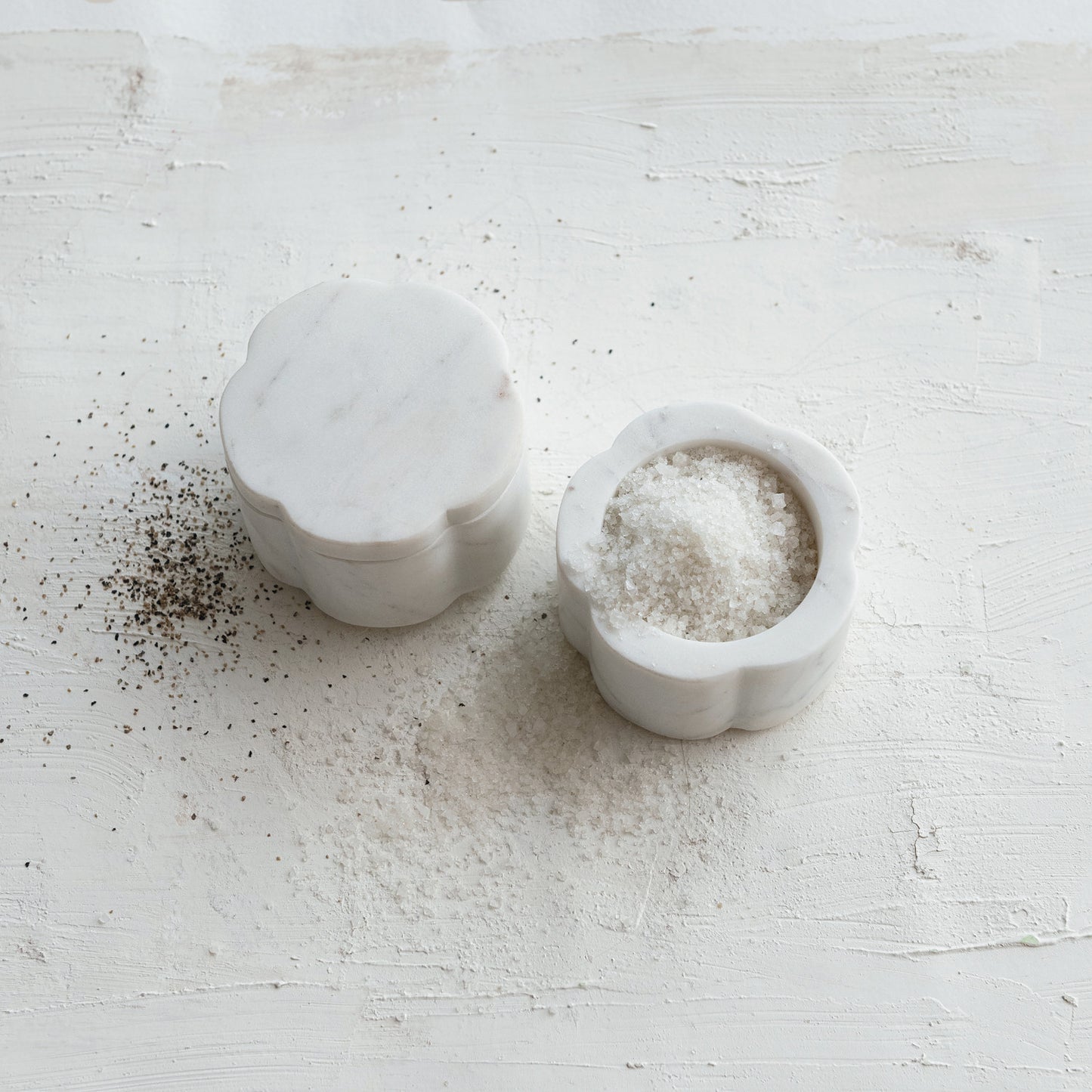 Close-up of the scalloped marble pinch pots showcasing natural white marble variation and artisan craftsmanship.