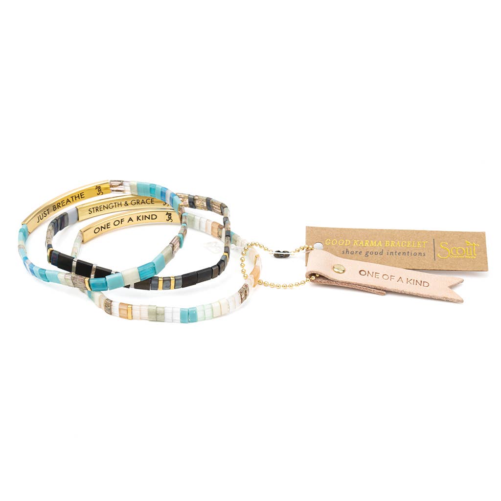 Good Karma Miyuki Bracelet featuring mint, peach, and gold Japanese Miyuki glass beads with a 14K gold-dipped engraved bar and Sparkle & Shine leather keepsake tag.