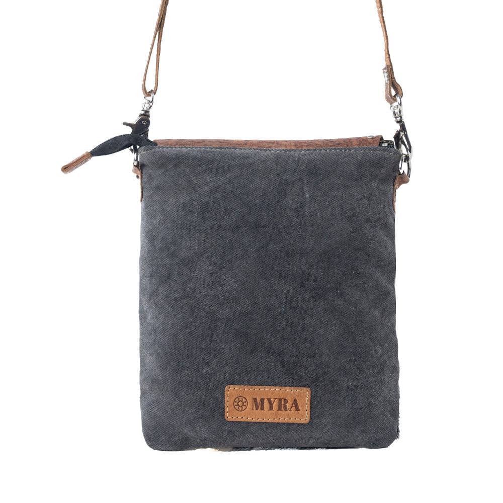 Stonebrook Canvas & Hairon Crossbody Bag in Spotted Ivory featuring genuine hair-on cowhide, textured leather, decorative silver studs, and an adjustable crossbody strap.