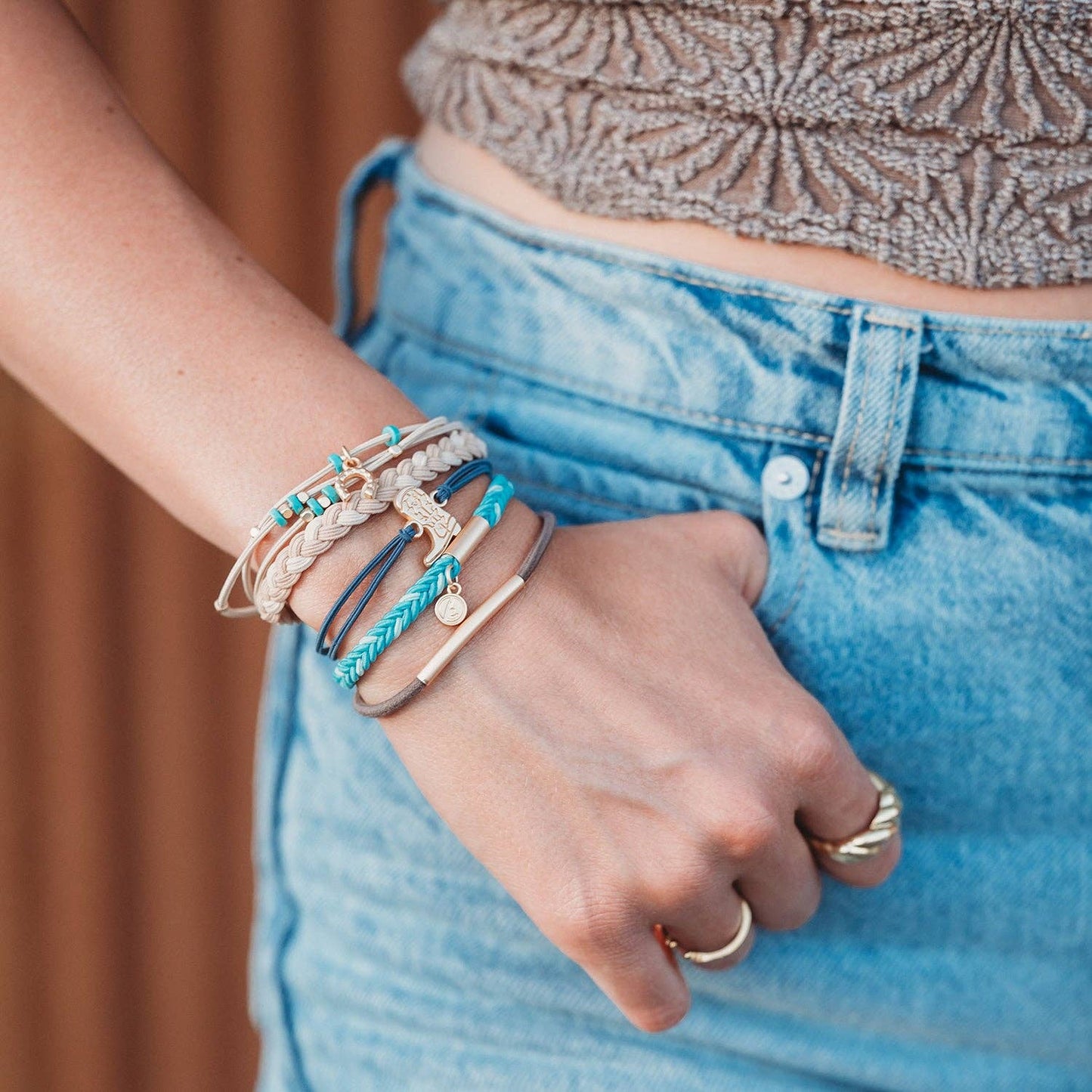 Stride set of five turquoise, blue, brown, cream, and teal hair tie bracelets with gold cowboy boot and horseshoe charms in size Large.