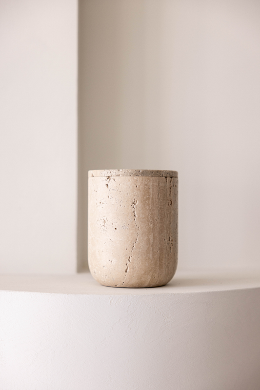 Natural travertine lidded storage canister styled on countertop for kitchen or bathroom organization