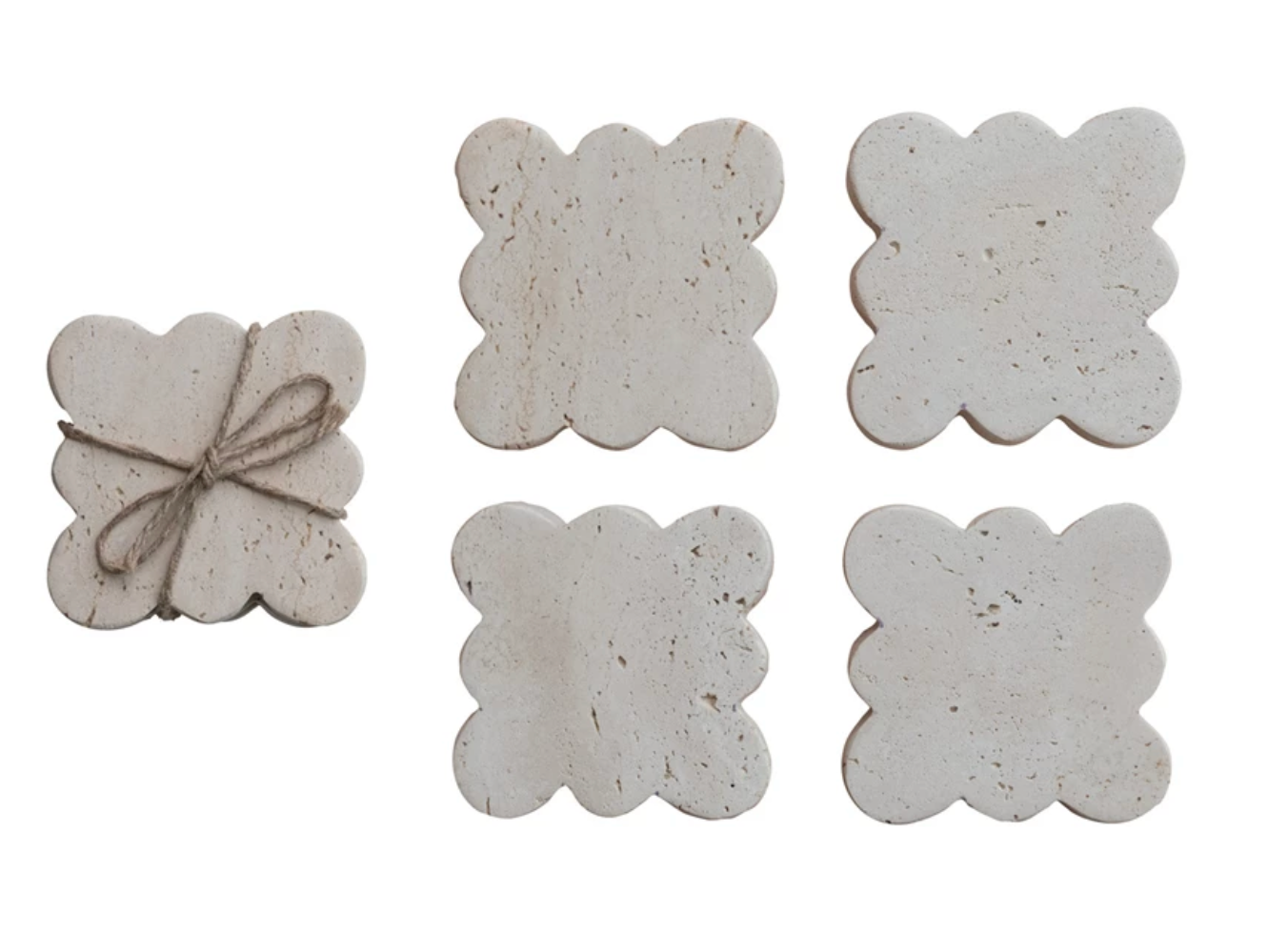 Set of four travertine coasters featuring decorative scalloped edges and natural stone variation.