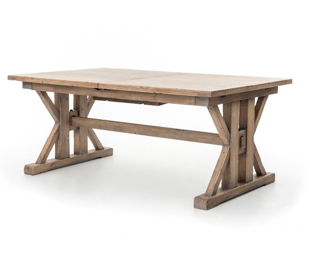 Tuscanspring Extendable Dining Table in a warm sun-dried wheat finish with architectural criss-cross supports.