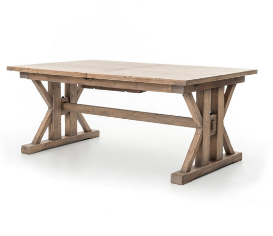 Tuscanspring Extendable Dining Table in a warm sun-dried wheat finish with architectural criss-cross supports.
