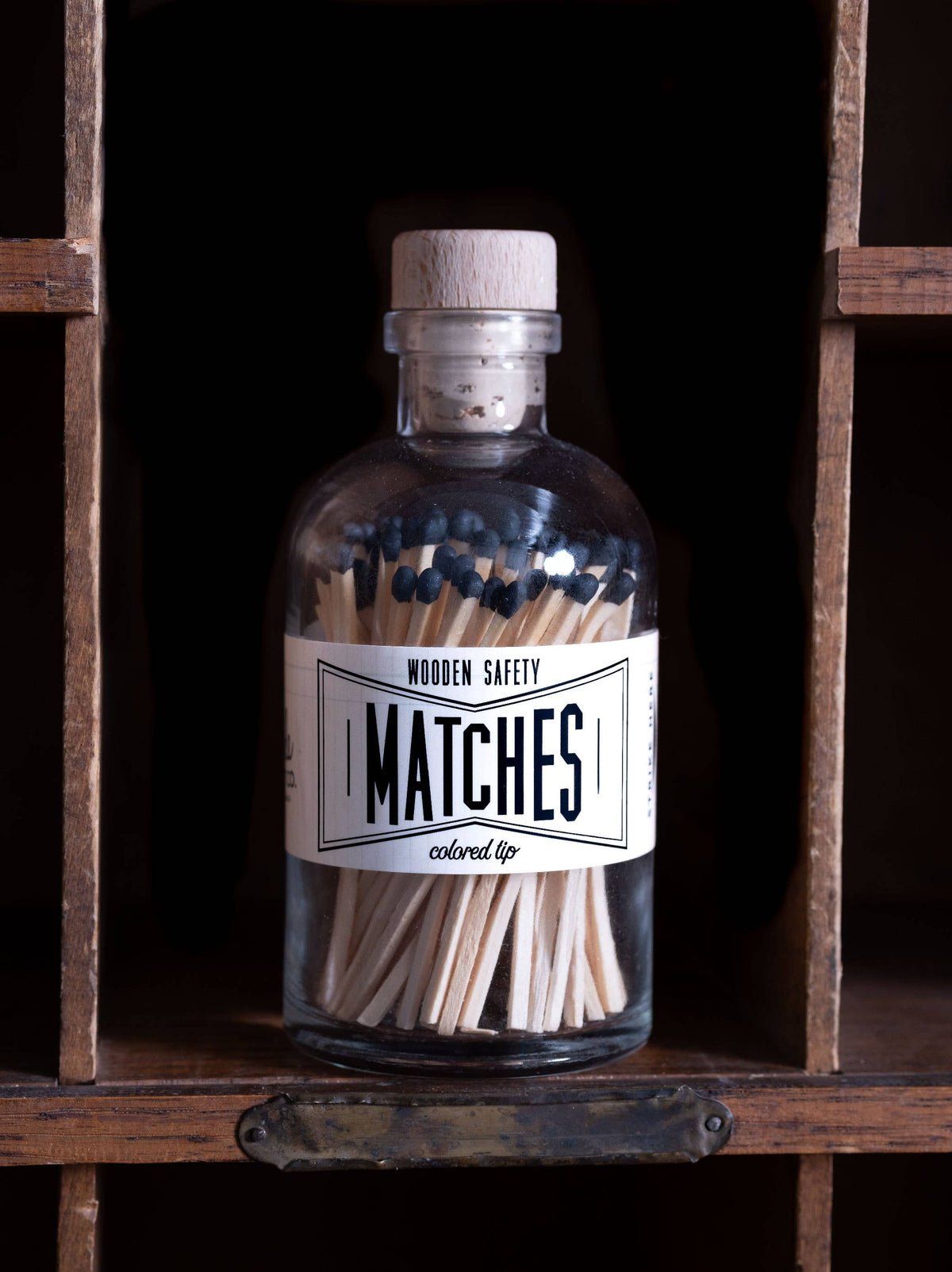 Vintage apothecary matches with classic black match tips, nostalgic label, and wooden cork top.