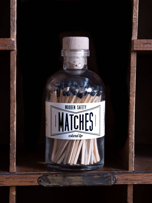Vintage apothecary matches with classic black match tips, nostalgic label, and wooden cork top.
