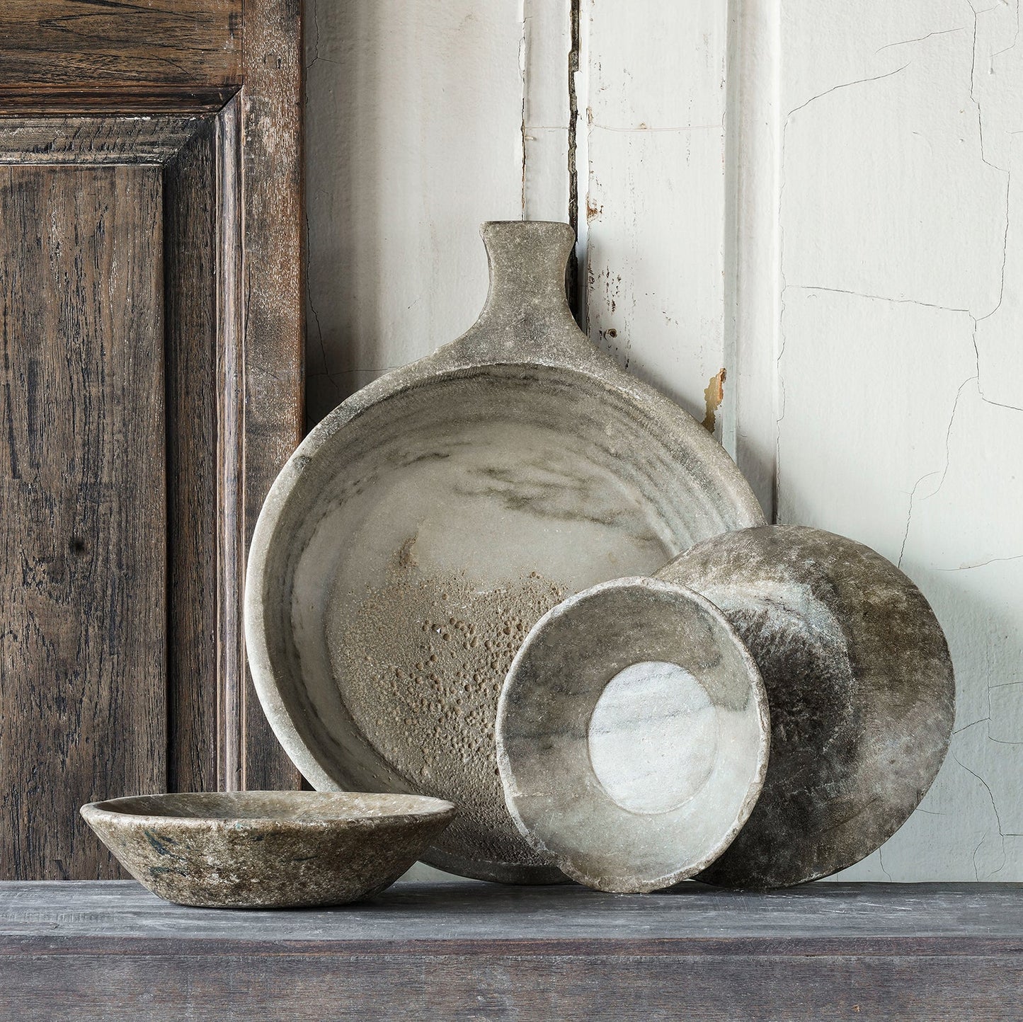 Vintage round marble bowl from India with a shallow profile, neutral stone coloration, and naturally aged patina.