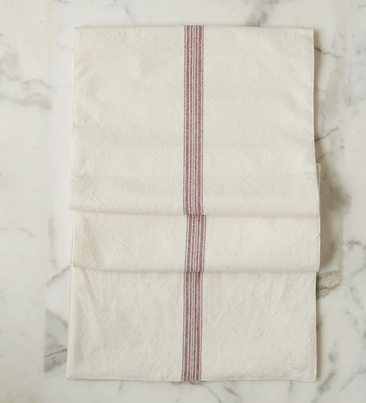 Folded fabric with red stripes on a marble surface